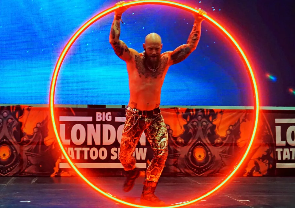 Performer framed by a glowing red hoop
