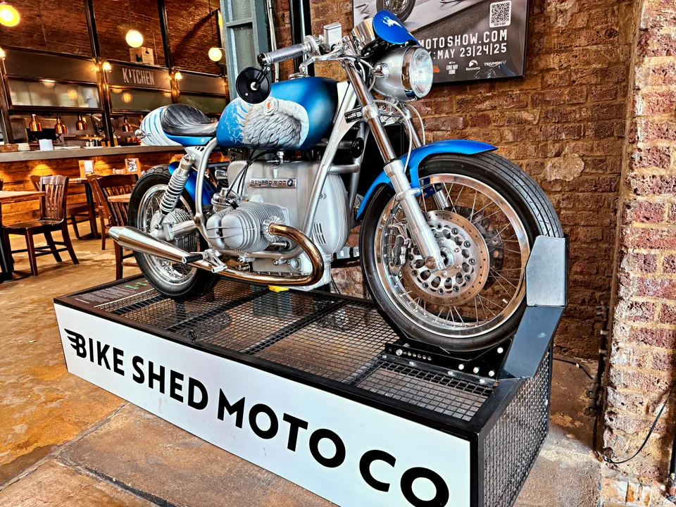 Classic motorcycle displayed beneath brick arches