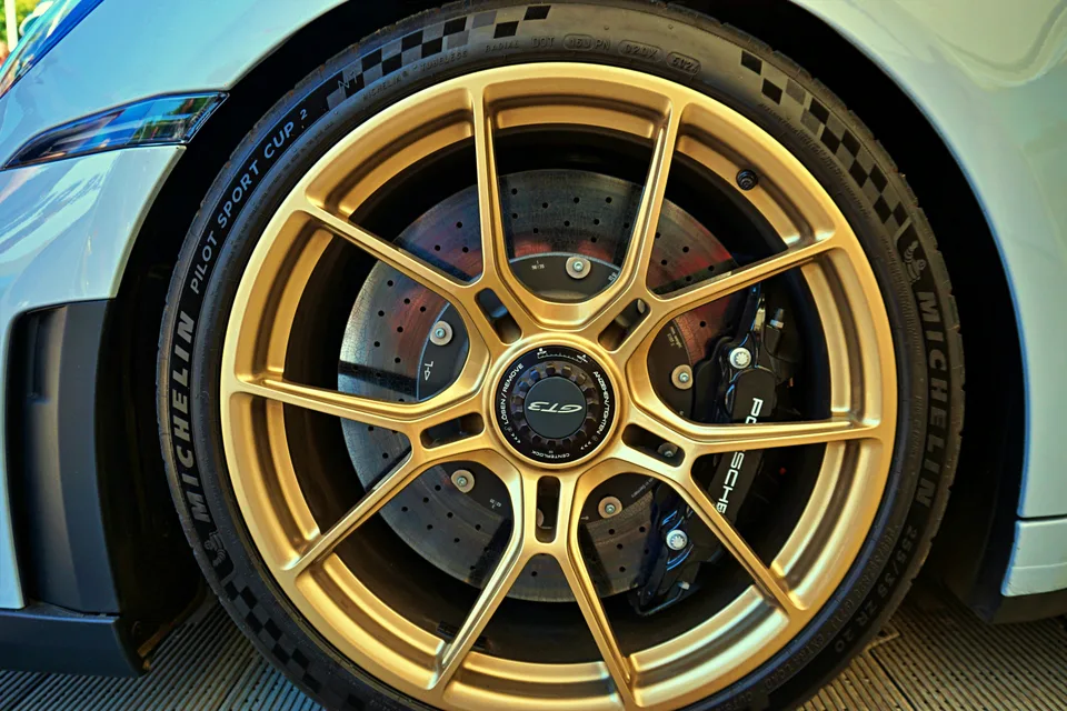 Gold Porsche wheel and brake detail