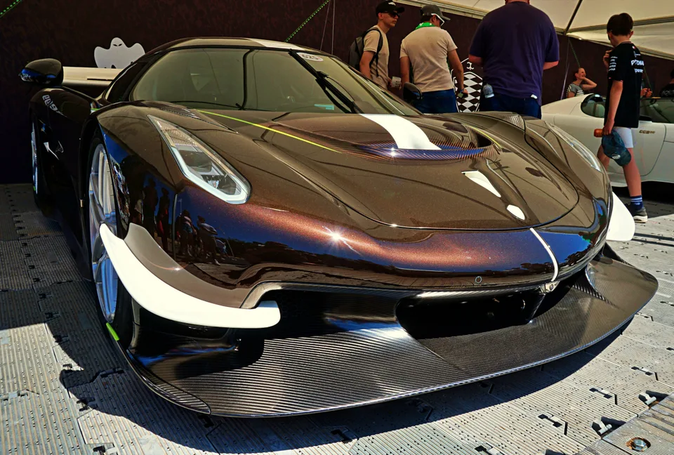 Dark sports car with sculpted front bodywork