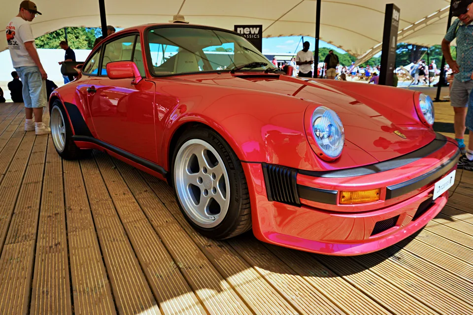 Red classic Porsche beneath a show tent