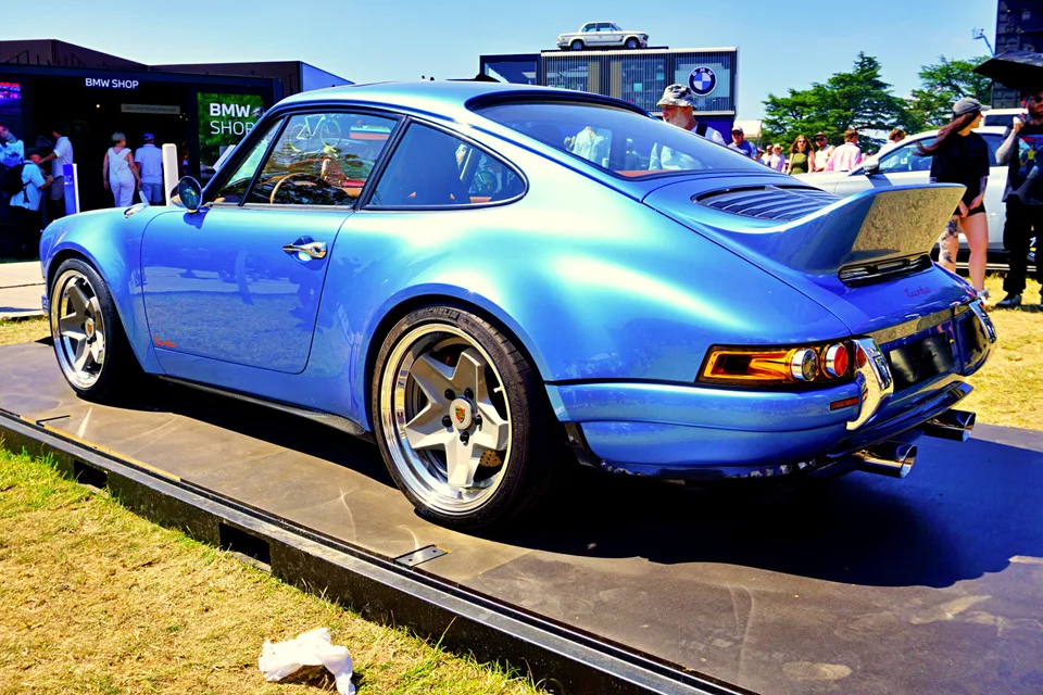 Metallic blue Porsche 911 restomod, rear three-quarter view