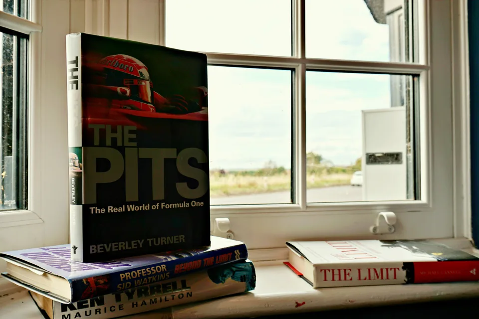 Motoring books on a sunlit window sill
