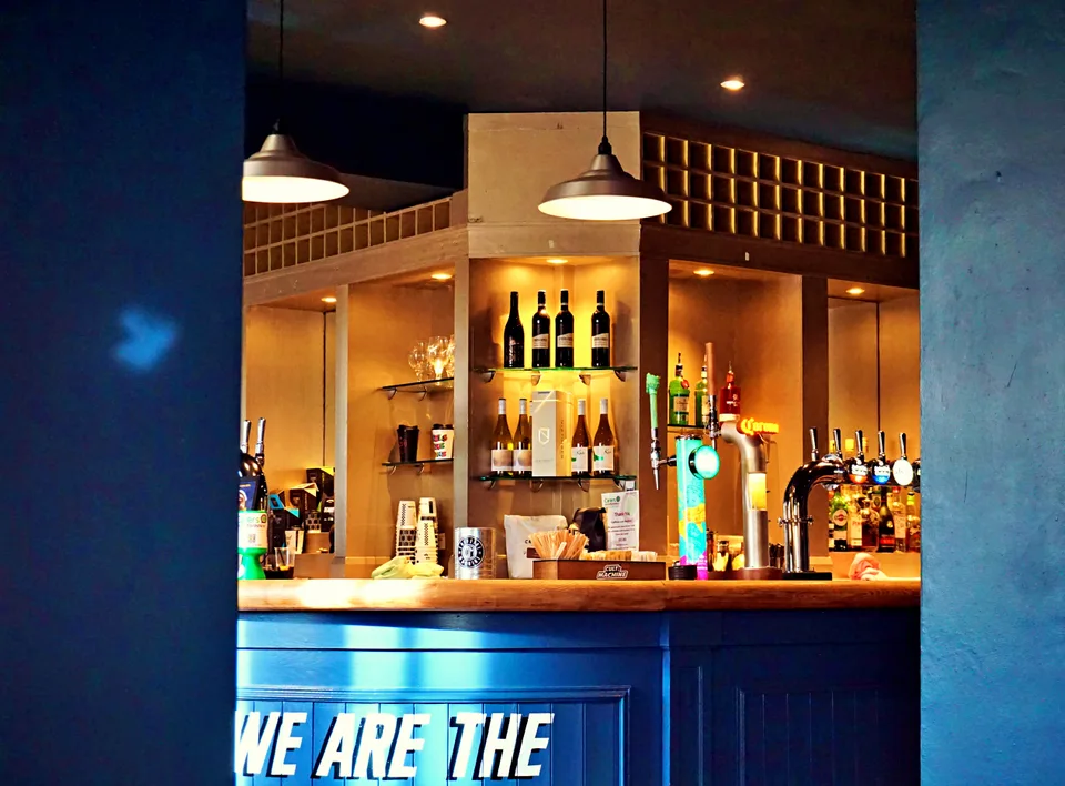 Blue bar and warm pendant lighting