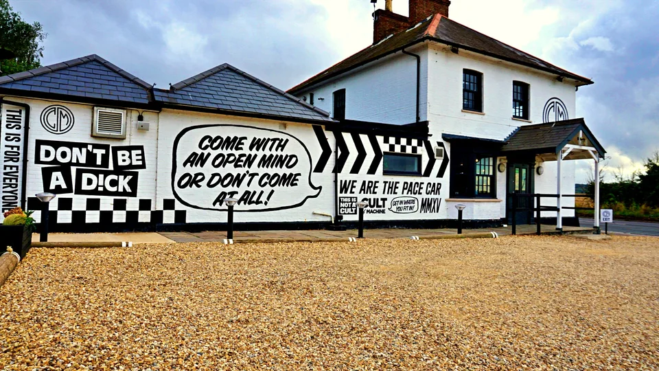 Black and white lettering across a roadside building