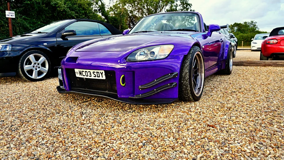 Purple Honda sports car, front three-quarter view