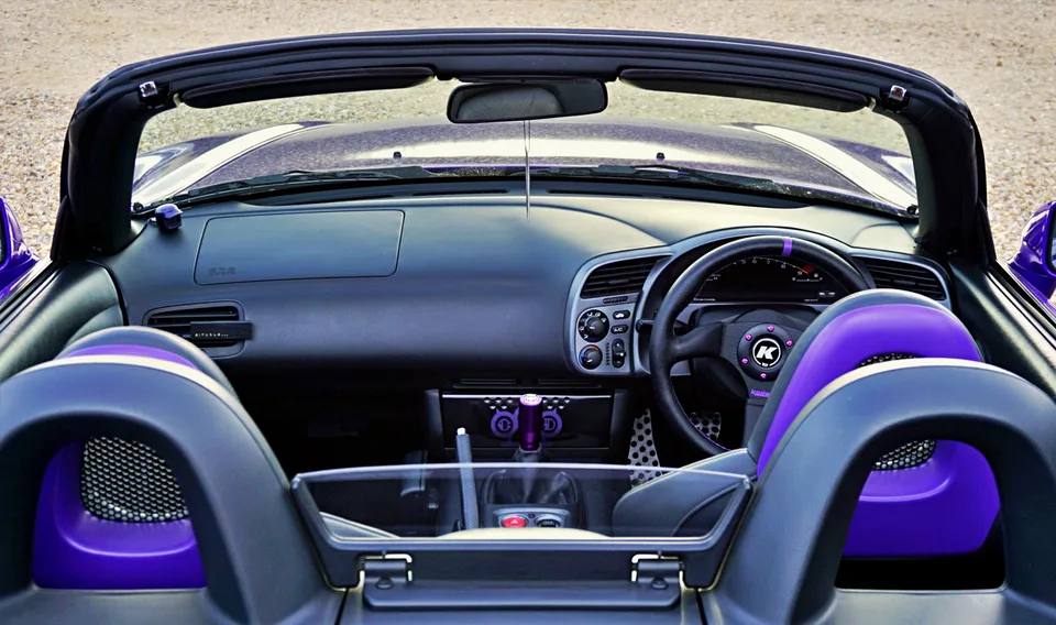 Open-top purple sports car cabin